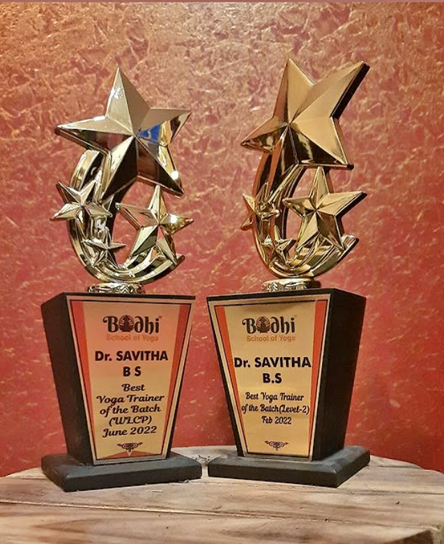 Best Yoga Trainer trophies awarded to Dr. Savitha B S by Bodhi School of Yoga